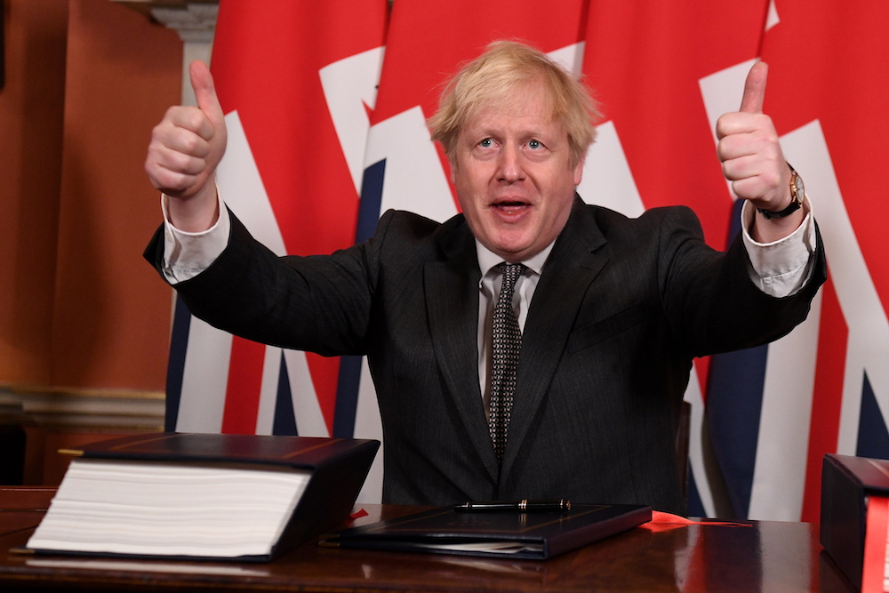 Britain's Prime Minister Boris Johnson gives a thumbs up after signing the Brexit trade deal with the EU at number 10 Downing Street in London, Britain December 30, 2020. u00e2u20acu201d Leon Neal/Pool via Reuters