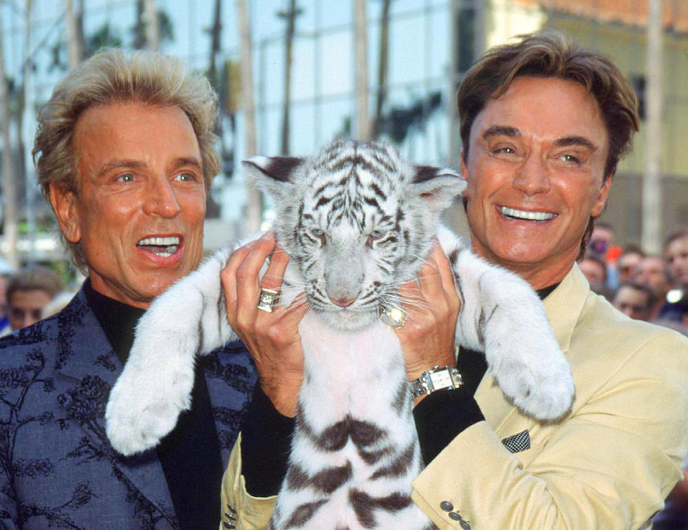 In this file photo taken on September 23, 1999, magicians Siegfried Fischbacher (left) and Roy Horn pose during their Walk of Fame ceremony in Hollywood. u00e2u20acu201d AFP pic