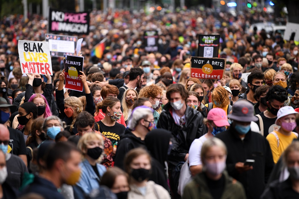 Protesters are seen during an Invasion Day rally in Melbourne, Tuesday, January 26, 2021. u00e2u20acu201d AAP Image/James Ross via Reuters