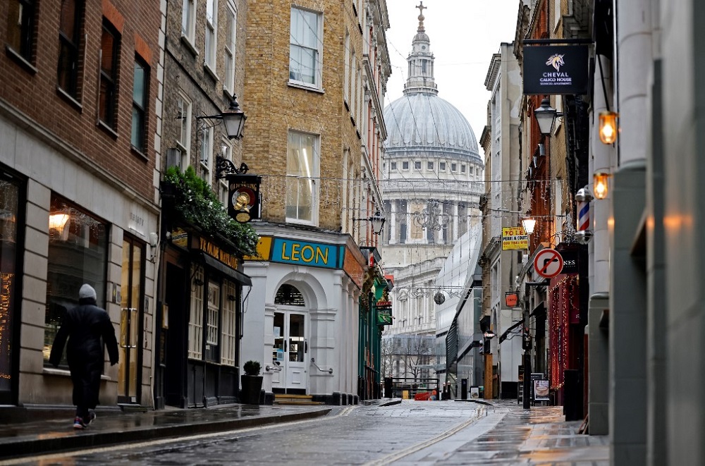 A pedestrian walks past shops, temporarily closed-down due to Covid-19 restrictions, as Britain enters a national lockdown in London on January 5, 2021. u00e2u20acu201d AFP pic