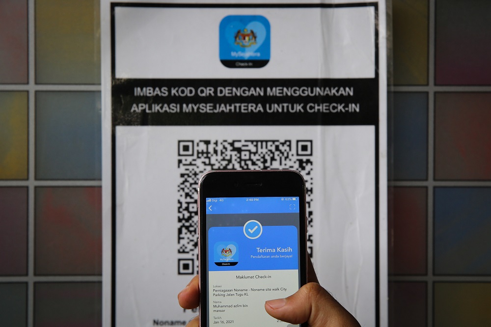 A user scans a QR code via the My Sejahtera app at a restaurant in Kuala Lumpur January 16, 2020. u00e2u20acu201d Picture by Yusof Mat Isa