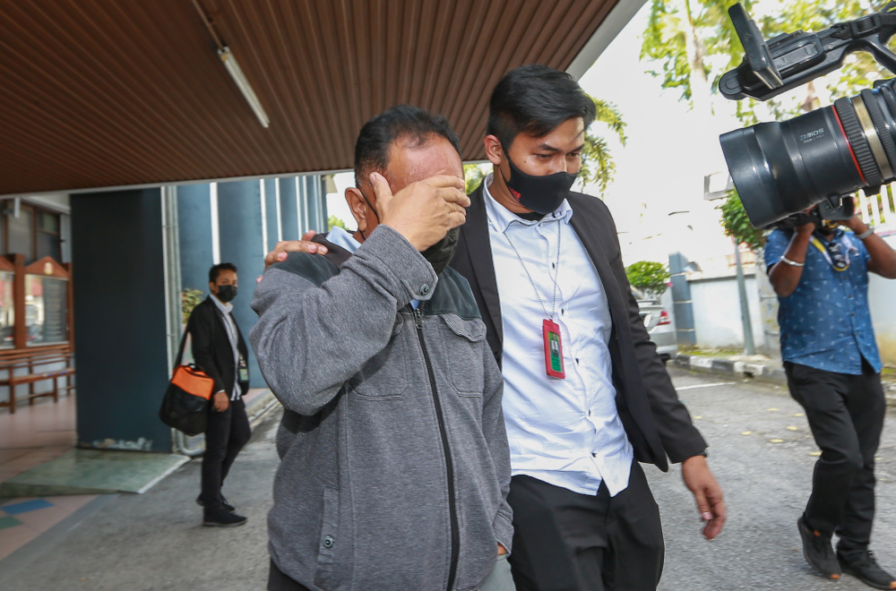 A 60-year-old police corporal claimed trial at the Session Court in Ipoh to 43 counts of accepting bribes totalling RM146,350 January 26, 2021. u00e2u20acu201d Picture by Farhan Najib