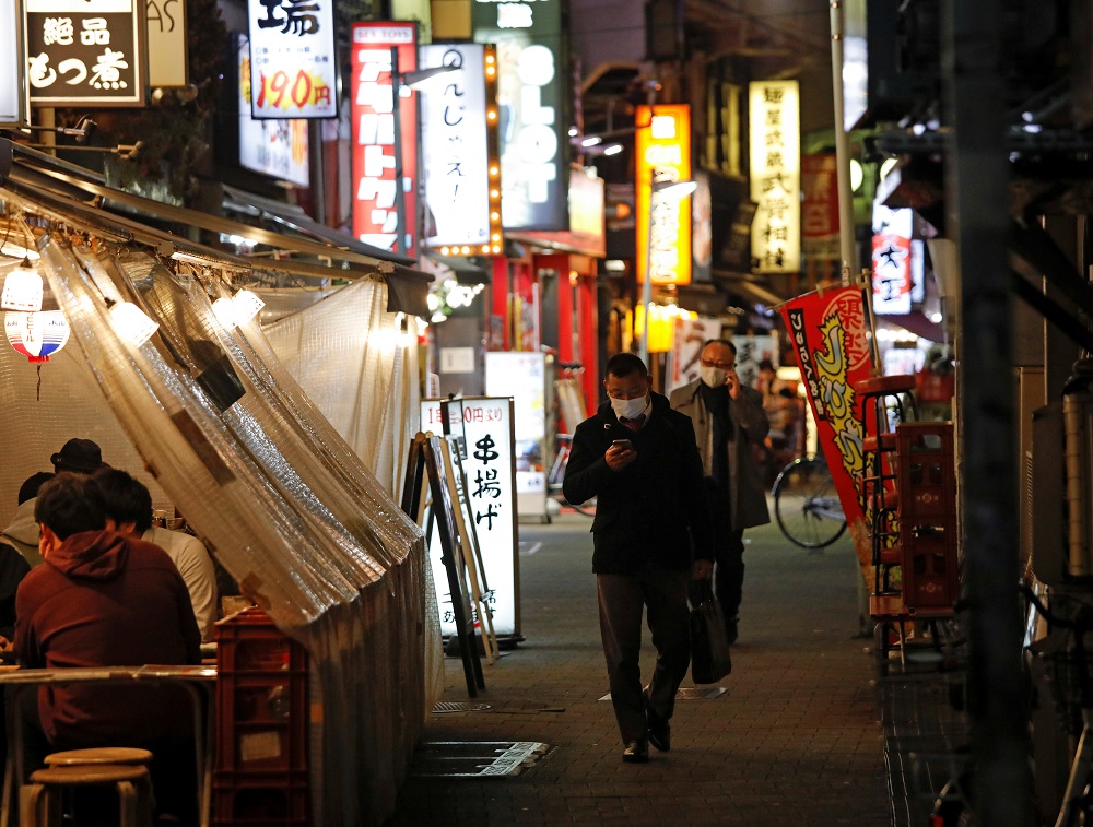 People wearing protective face masks walk past at a Japanese izakaya pub alley, amid the coronavirus disease outbreak, in Tokyo January 5, 2021. u00e2u20acu2022 Reuters pic