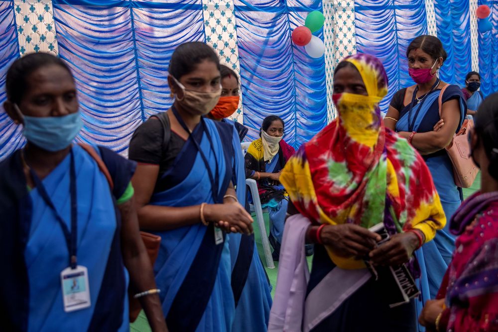 Healthcare workers wait to receive COVISHIELD, a Covd-19 vaccine manufactured by Serum Institute of India, during one of the world's largest Covid-19 vaccination campaigns at Mathalput Community Health Centre in Koraput district of the eastern state of Od