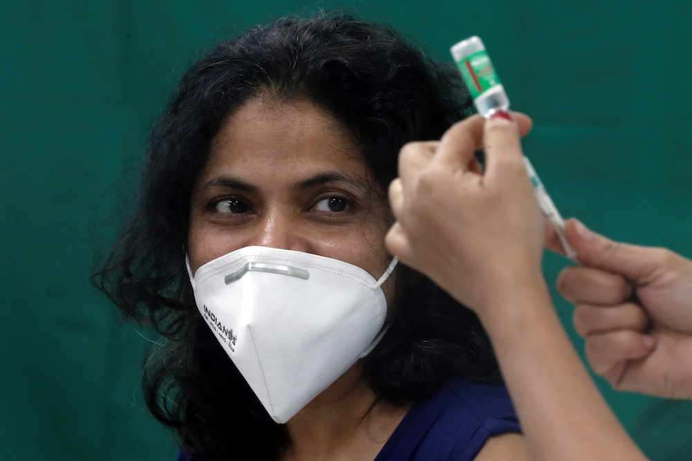 A healthcare worker looks on as a nurse prepares a dose of the AstraZeneca’s COVISHIELD vaccine, during the coronavirus disease vaccination campaign, at a medical centre in Mumbai, India, January 16, 2021. — Reuters pic