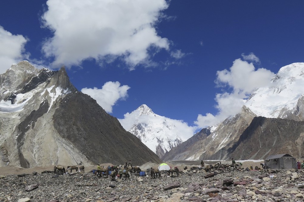 In this file photo taken on August 14, 2019, porters set up tents at the Concordia camping site in front of K2 summit (centre) in the Karakoram range of Pakistanu00e2u20acu2122s mountain northern Gilgit region. u00e2u20acu201d AFP pic