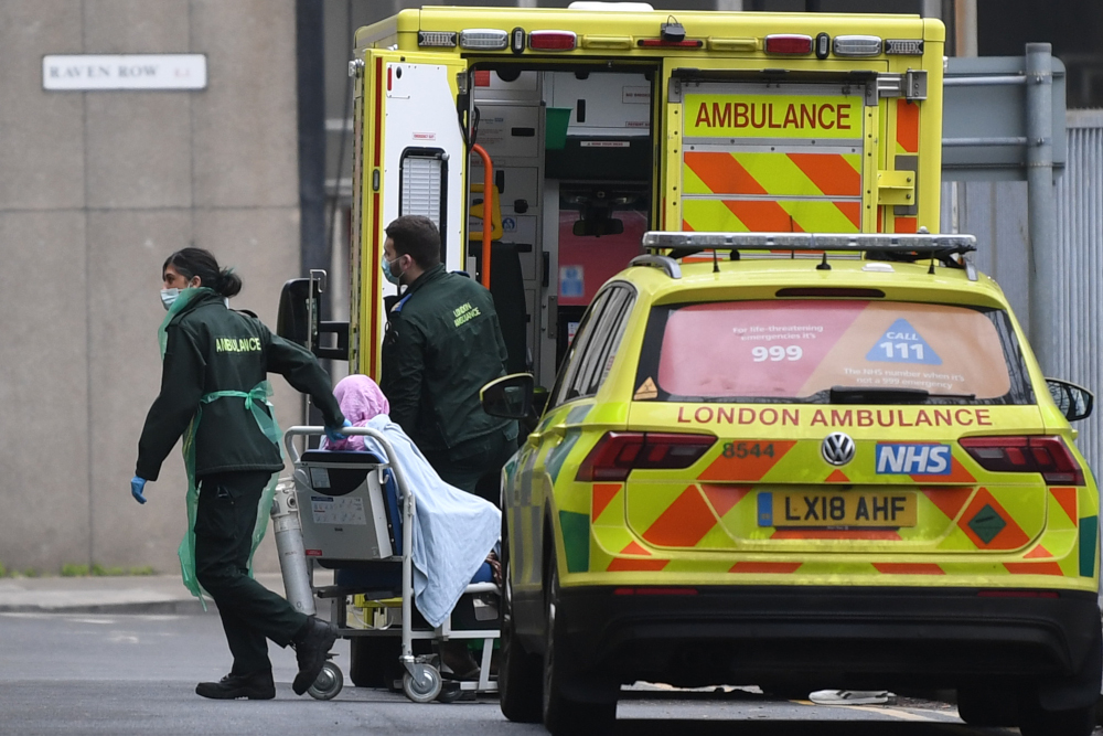 A patient is wheeled from an ambulance into the Royal London hospital in London January 10, 2021 as surging cases of the novel coronavirus are placing health services under increasing pressure. u00e2u20acu201d AFP pic 