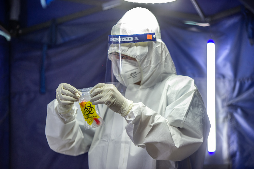 A health worker puts a test tube into biohazard plastic after collecting a sample for Covid-19 testing in Jalan Pudu, Kuala Lumpur, January 18, 2021. u00e2u20acu201d Picture by Shafwan Zaidon