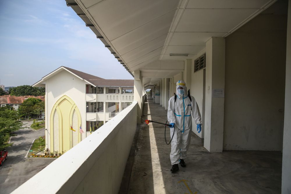 A Fire and Rescue personnel wearing protective gear sprays disinfectant at Sekolah Rendah Agama Kota Damansara 5 January 19, 2021. u00e2u20acu201d Picture by Yusof Mat Isa