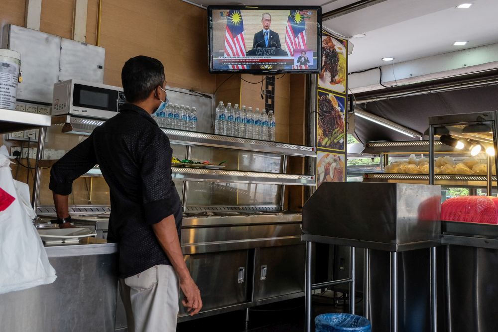 A man watches a live telecast of Prime Minister Tan Sri Muhyiddin Yassin's speech at a restaurant in Shah Alam January 12, 2020. — Picture by Yusof Mat Isa