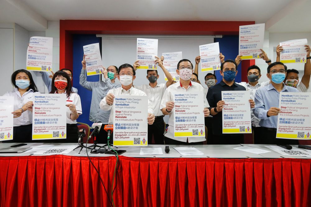 Penang DAP chairman Chow Kon Yeow (third from left), along with other party members, hold up placards demanding the reinstatement of state infrastructure projects at Wisma DAP in George Town January 7, 2021. u00e2u20acu201d Picture by Sayuti Zainudin