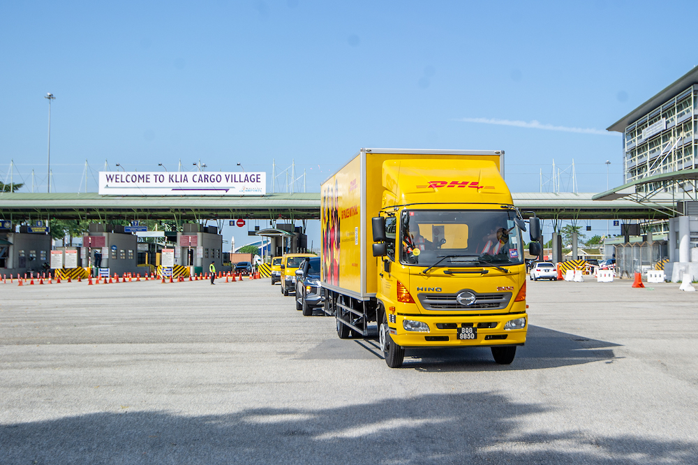 A convoy of DHL Express vehicles carry the first batch of Pfizer-BioNTech's Covid-19 vaccine with police escort from Cargo Village in KLIA, February 21, 2021. u00e2u20acu201d Picture by Shafwan Zaidon