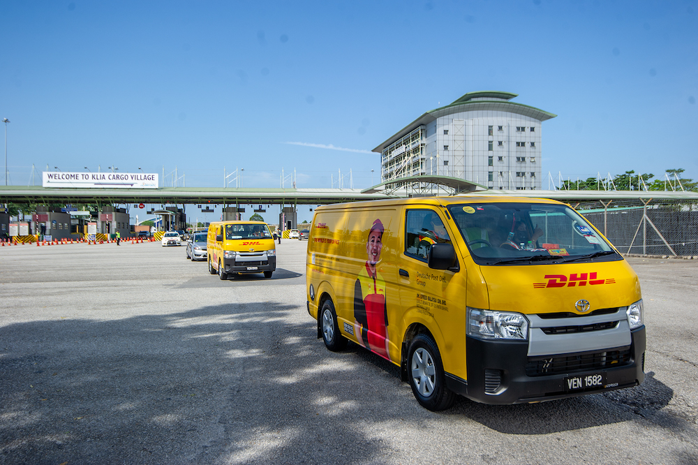 A convoy of DHL Express vehicles carry the first batch of Pfizer-BioNTech's Covid-19 vaccine with police escort from Cargo Village in KLIA, February 21, 2021. — Picture by Shafwan Zaidon