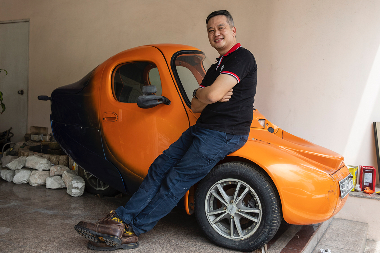 Former Singapore Armed Forces mechanic Clarence Tan with his Corbin Sparrow, a three-wheeled electric car. He invested S$250,000 to set up The Green Car Company in 2008, with a dream to manufacture 2,500 two-seater EVs a year out of a workshop the size of