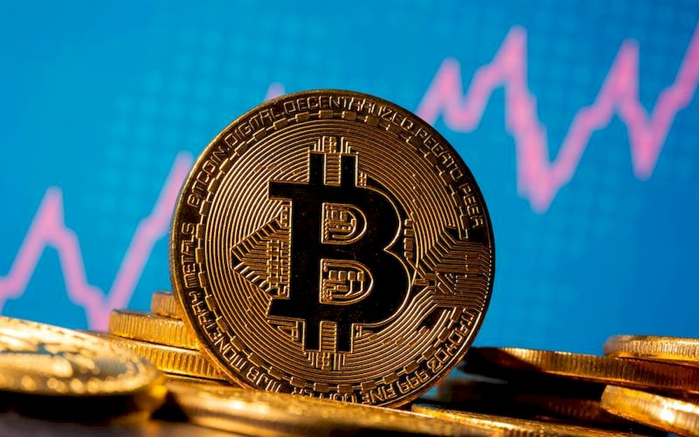 A representation of virtual currency Bitcoin is seen in front of a stock graph in this illustration taken November 19, 2020. u00e2u20acu201d Reuters pic