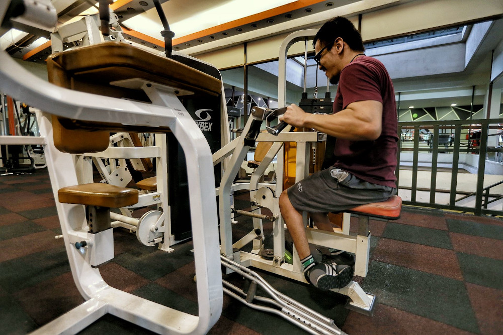 Disabled gym-goer Mohammad Arif Aiman Mohammad Ridzuan enjoys a free workout at Enrich Fitness centre with zero fees, February 12, 2021. u00e2u20acu201d Picture by Ahmad Zamzahuri