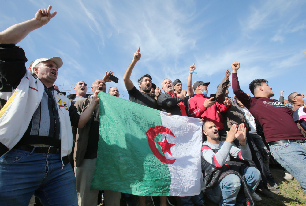 People gesture and carry a national flag outside the Kolea prison, west of the capital Algiers February 19, 2021. u00e2u20acu201d Reuters pic
