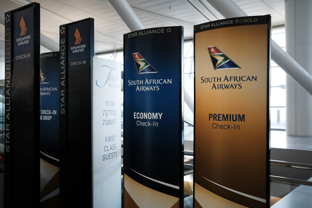 Signs for South African Airways are pushed into a corner at an international terminal at John F. Kennedy Airport (JFK) January 25, 2021 in New York City. u00e2u20acu201d Spencer Platt/Getty Images via AFPnn