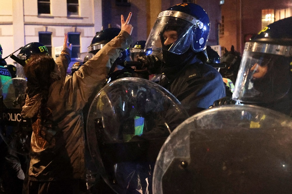 A demonstrator gestures close to police officers during a protest against a newly proposed policing bill, in Bristol March 26, 2021. u00e2u20acu201d Reuters pic