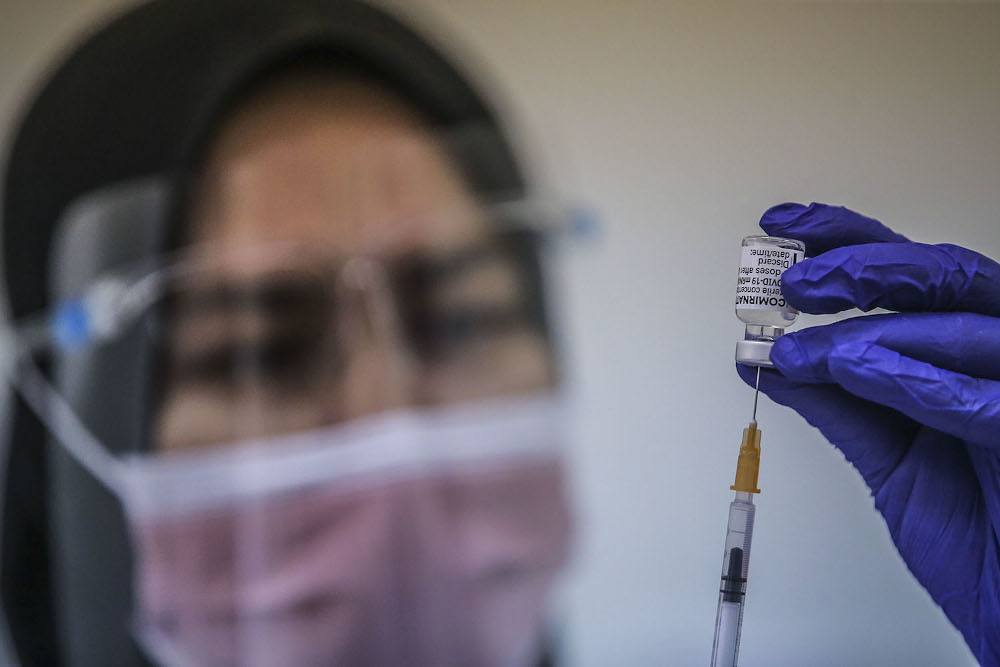 A health worker loads a syringe with a dose of the Pfizer-BioTech Covid-19 vaccine at the UiTM Hospital in Sungai Buloh March 2, 2021. ― Picture by Hari Anggara