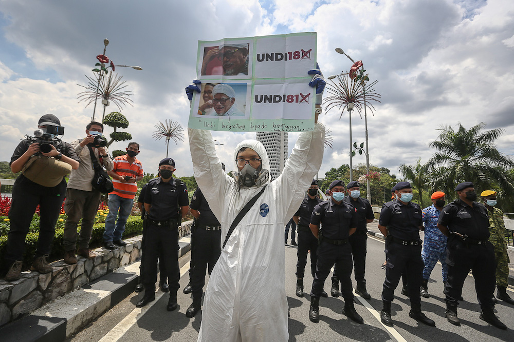 Protesters hold placards in front of Parliament building to protest the Election Commission's (EC) delay in allowing 18-years old to vote in Kuala Lumpur March 27, 2021. u00e2u20acu201dPicture by Yusof Mat Isa