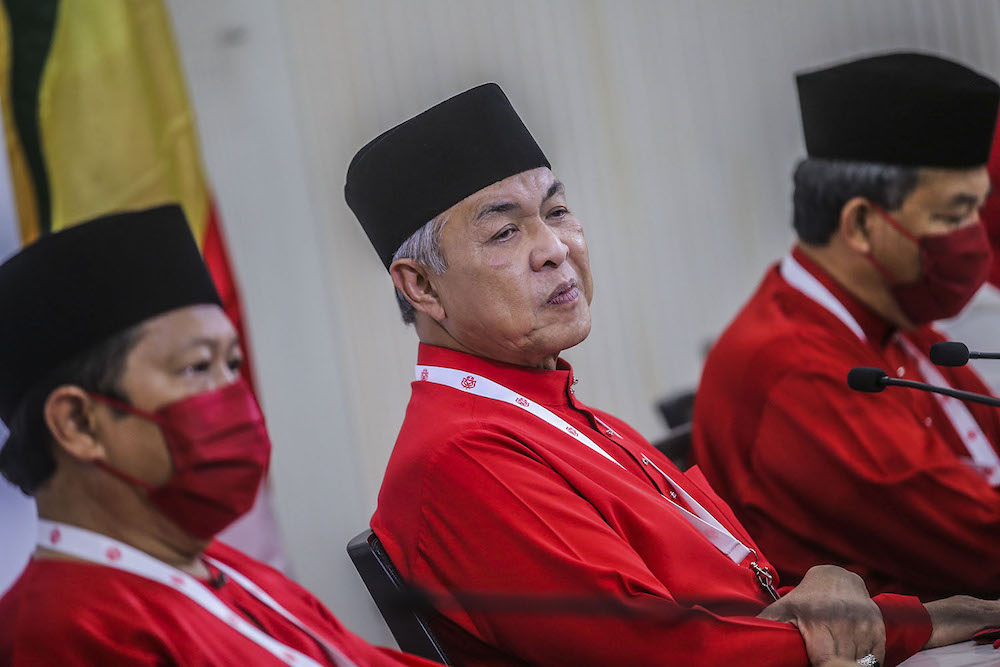 During the general assembly, Umno president Datuk Seri Ahmad Zahid Hamidi (centre) warned 'parasites' within the party to not support PN or Bersatu. ― Picture by Hari Anggara