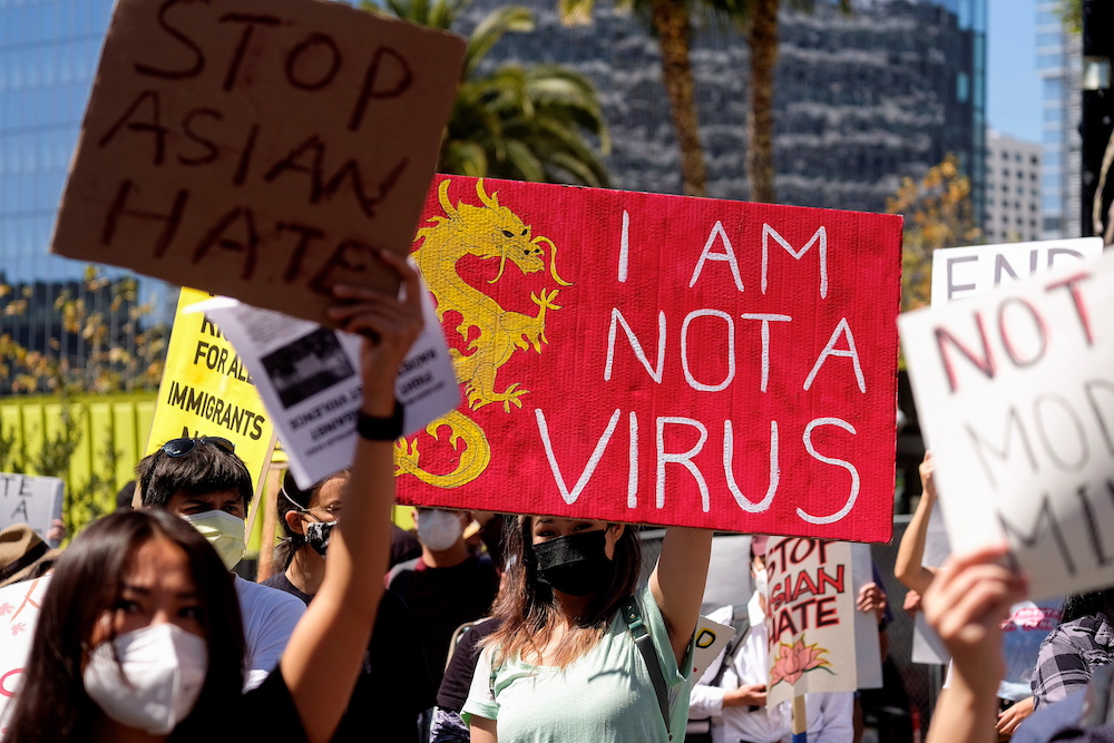 Demonstrators hold signs during a rally against anti-Asian hate crimes outside City Hall in Los Angeles, California March 27, 2021. u00e2u20acu201d Reuters pic