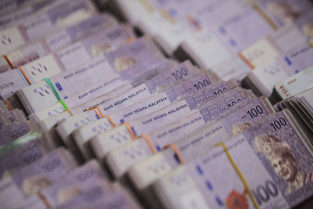 Some of the cash seized by police is shown during a press conference at Bukit Aman March 30, 2021. u00e2u20acu2022 Picture by Hari Anggara