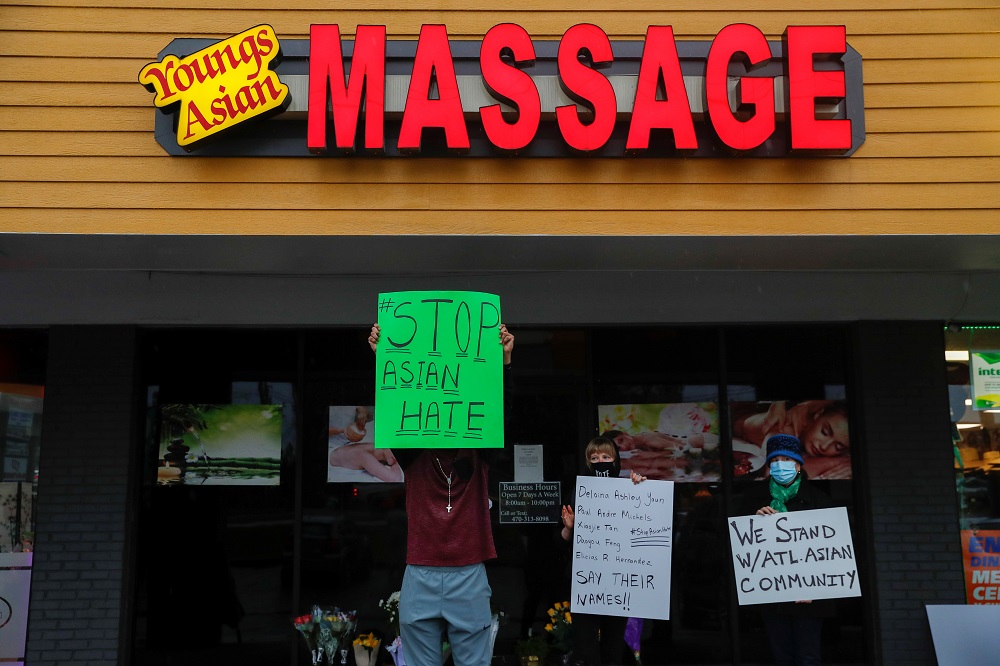 People hold signs outside Gold Spa following the deadly shootings in Acworth, Georgia March 17, 2021. u00e2u20acu2022 Reuters pic