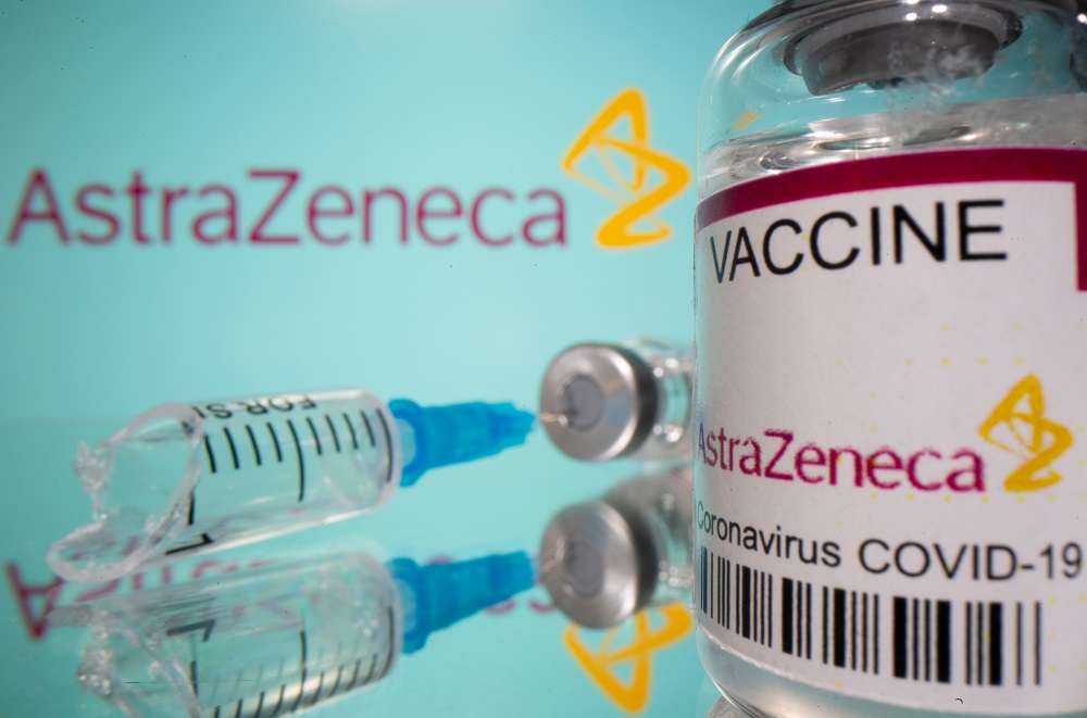 A vial labelled u00e2u20acu02dcAstraZeneca Covid-19 Coronavirus Vaccineu00e2u20acu2122 and a broken syringe are seen in front of a displayed AstraZeneca logo in this illustration taken March 15, 2021. u00e2u20acu2022 Reuters pic