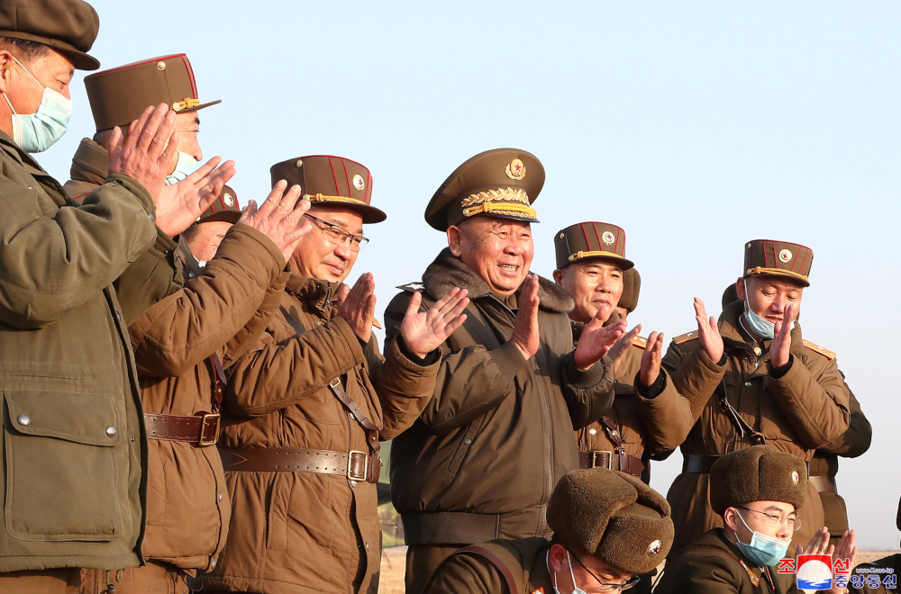 Ri Pyong Chol and other military officials applaud after the launch of a newly developed new-type tactical guided projectile March 25, 2021 in this photo released March 26, 2021 in Pyongyang, North Korea. u00e2u20acu201d KCNA pic via Reuters 