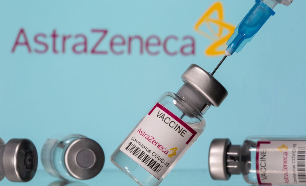 Vials labelled ‘Astra Zeneca Covid-19 Coronavirus Vaccine’ and a syringe are seen in front of a displayed AstraZeneca logo, in this illustration photo taken March 14, 2021. — Reuters pic