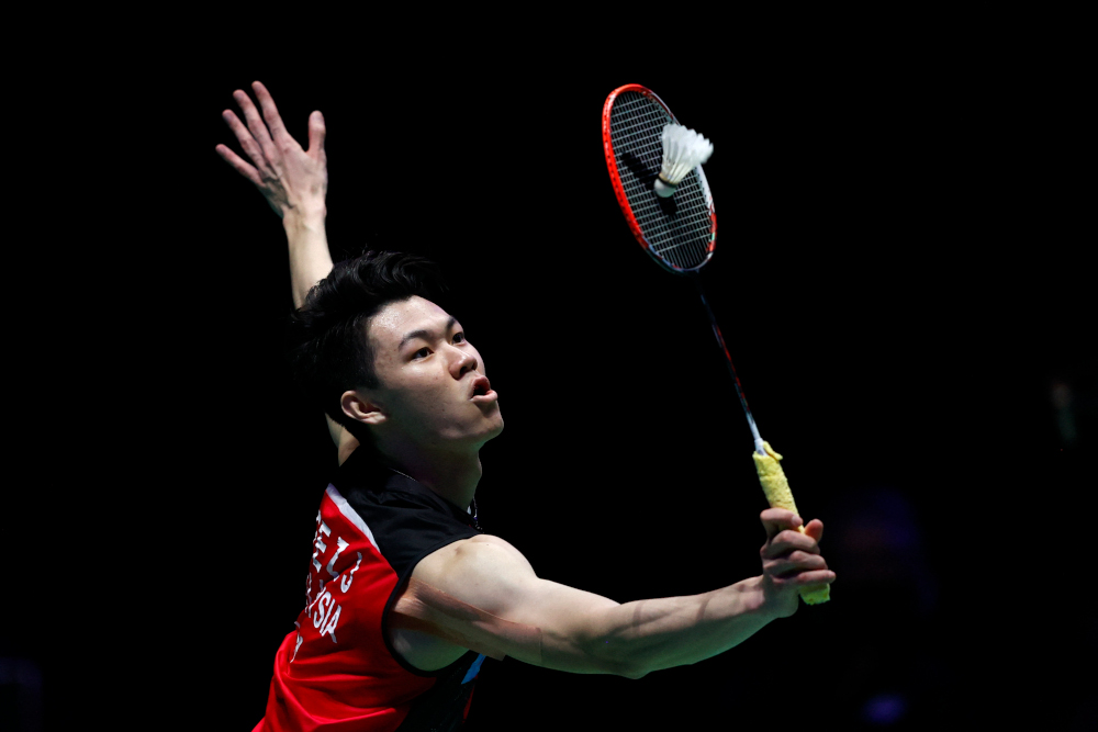 Lee Zii Jia returns against Denmarku00e2u20acu2122s Viktor Axelsen during the menu00e2u20acu2122s singles final of the All England Open Badminton Championship at the Utilita Arena in Birmingham, central England, March 21, 2021. u00e2u20acu201d AFP pic 