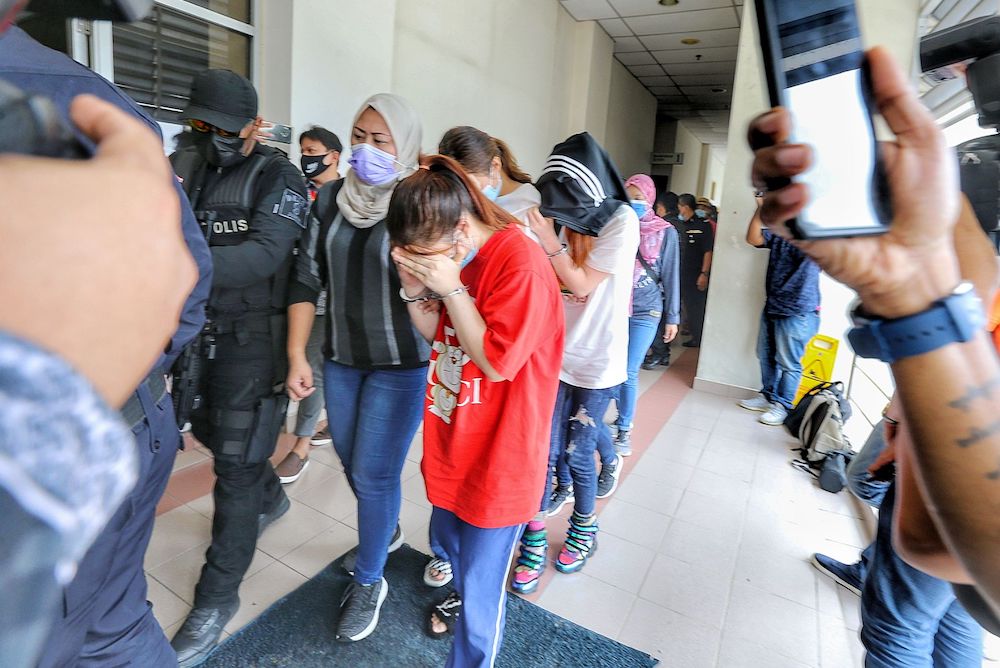 Fourteen members of the Nicky Gang at the Sessions Court in Petaling Jaya April 9, 2021. u00e2u20acu201d Picture by Ahmad Zamzahuri