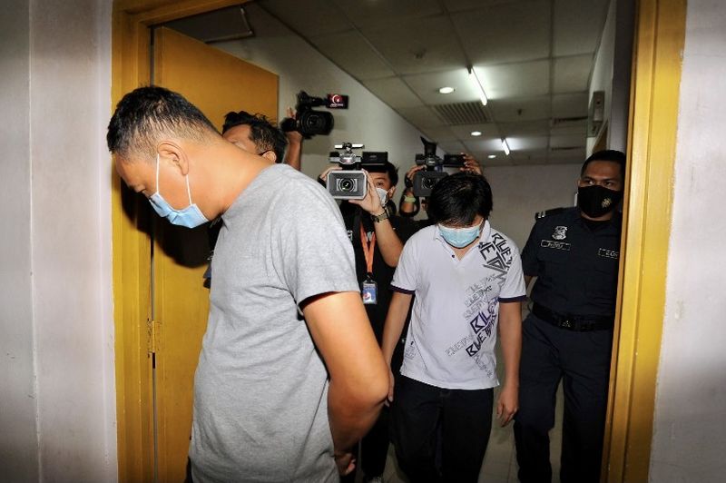 LY Frozen Food Sdn Bhd director Yong Chee Keong (front) and the companyu00e2u20acu2122s manager Chong Kim Kuang are arrive at the Sessions Court in Johor Baru April 22, 2021. u00e2u20acu201d Picture by Ben Tan