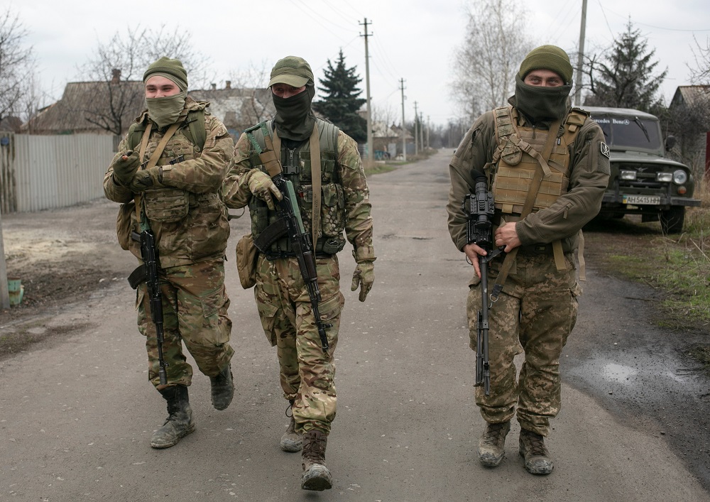 File photo of service members of the Ukrainian armed forces walking along a street in the town of Marinka in Donetsk Region, Ukraine April 14, 2021. ― Reuters pic