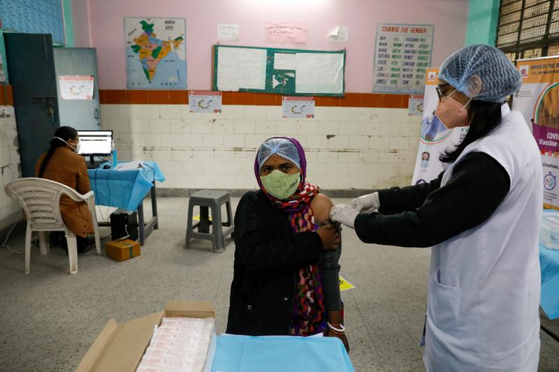 A health worker and a volunteer take part in a nationwide trial run of Covid-19 vaccine delivery systems, inside a school, which has been converted into a temporary vaccination centre, in New Delhi January 8, 2021. — Reuters pic
