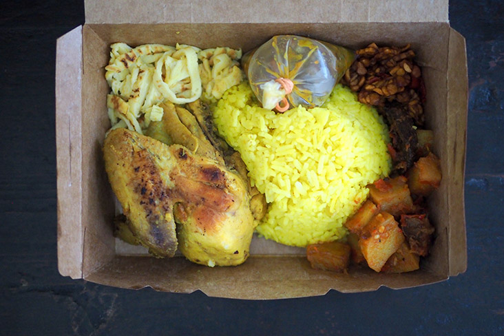 'Nasi kuning' can be eaten in the paper box and is available on FoodPanda and Grab Food