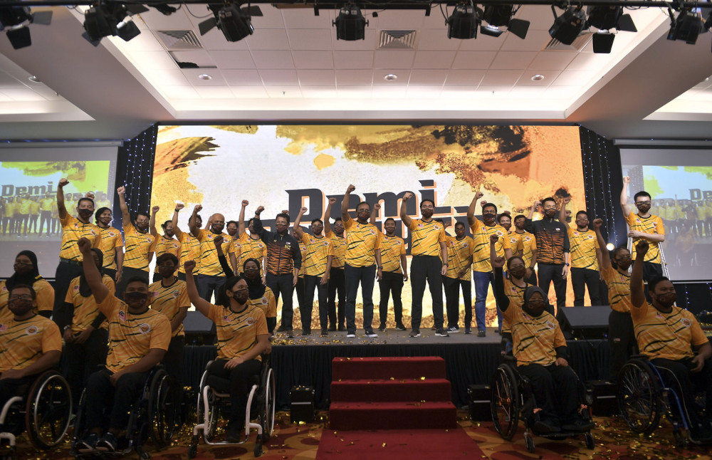 Youth and Sports Minister Datuk Seri Reezal Merican Naina is pictured with Malaysian athletes after the launch of the 100 Days to Tokyo ceremony launch at the National Sports Council in Kuala Lumpur, April 14, 2021. u00e2u20acu201d Bernama pic