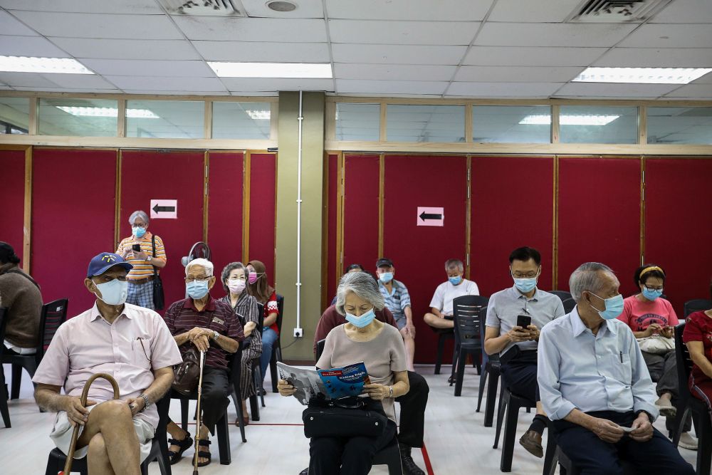 Senior citizens wait to receive their Covid-19 shot under phase two of Penang’s immunisation drive at the Caring Society Complex in George Town April 19, 2021. — Picture by Sayuti Zainudin