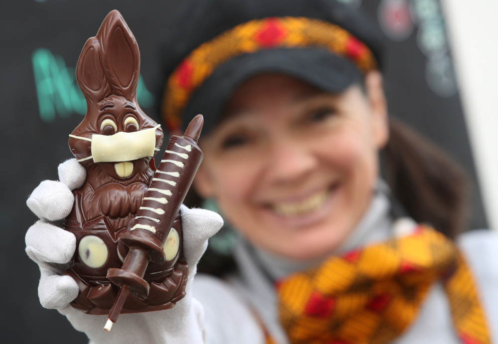 Belgian artisan chocolate maker Genevieve Trepant shows a chocolate bunny wearing a protective mask and holding a vaccine syringe called ‘L’Atch’a Azteka’ at her workshop Cocoatree in Lonzee, Belgium April 30, 2021. — Reuters pic