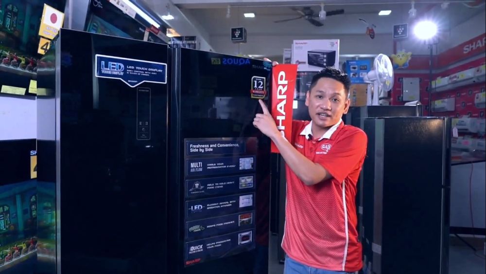 Grand Audio Product retail sales manager Long Han Ping pictured with Sharp’s new SBS Refrigerator. — Picture courtesy of Sharp
