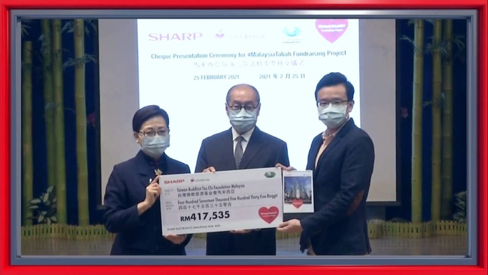 Sharp managing director Ting Yang Chung (far right) handing over a mock cheque worth RM417,535, collected for frontliners, to Tzu Chi Foundation representatives in Taiwan. — Picture courtesy of Sharp