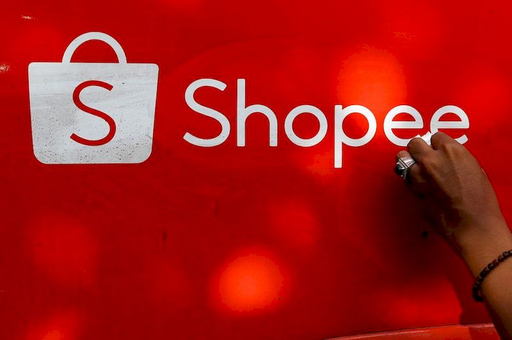A worker wipes the door of a car with the sign of Shopee, an Indonesian e-commerce platform, in Jakarta, Indonesia, February 5, 2021. u00e2u20acu201d Reuters pic