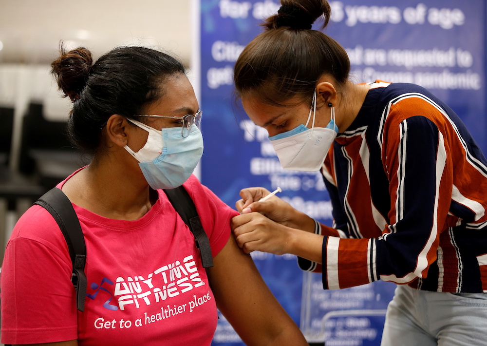  A woman receives a dose of Covishield, a coronavirus disease (Covid-19) vaccine manufactured by Serum Institute of India, at a vaccination centre in Ahmedabad, India, May 1, 2021. u00e2u20acu201d Reuters picnn