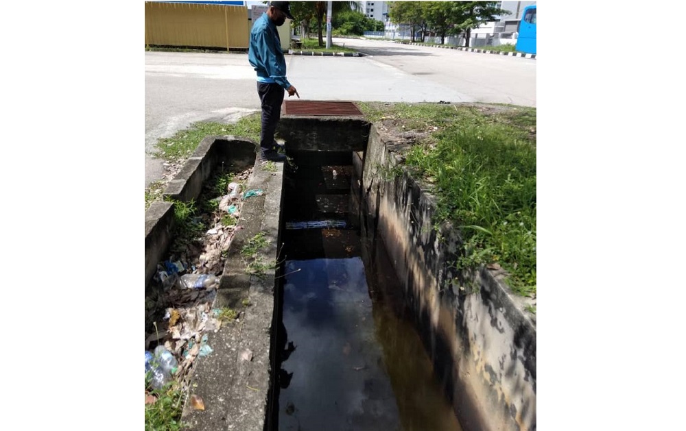 Officers from the Department of Enviromental collecting samples as they issue a fine to a factory in Bukit Minyak May 3, 2021. u00e2u20acu201d Picture courtesy of DOE 