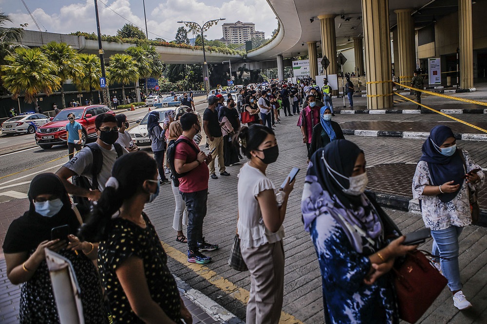 People wait to receive their AstraZeneca Covid-19 vaccine shot at the Vaccine Delivery Centre located at Kuala Lumpur World Trade Centre May 29, 2021. — Picture by Hari Anggara