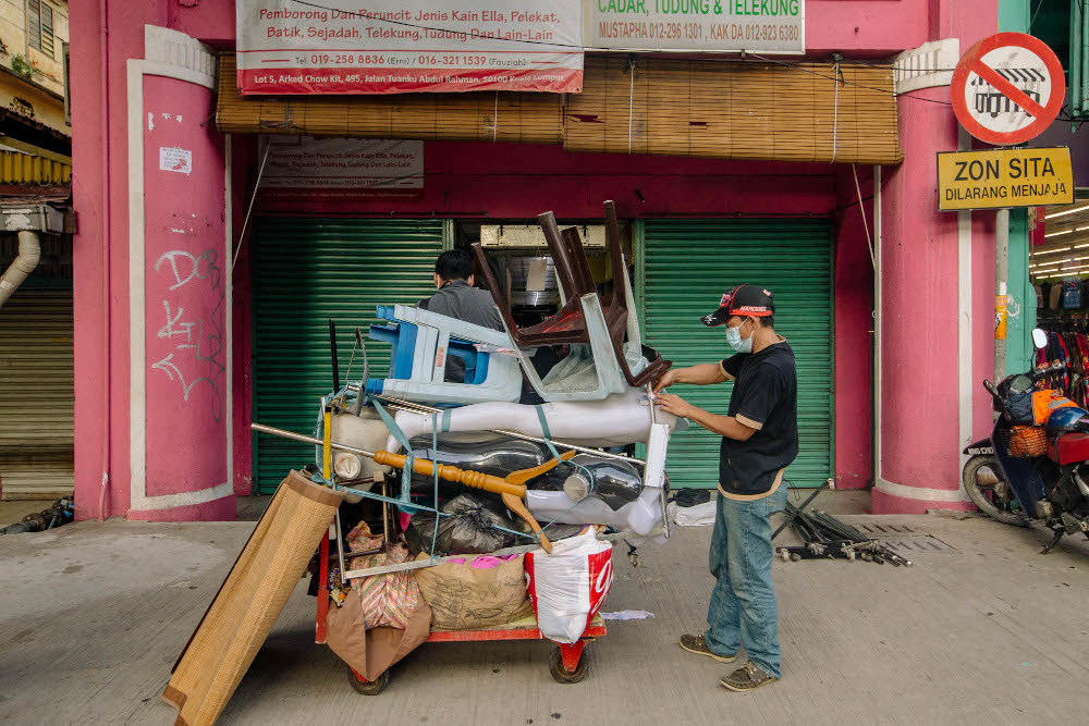 Shopkeepers close their stores in preparation for the the two-week movement control order (MCO) from June 1 to June 14 in Kuala Lumpur May 31, 2021. u00e2u20acu201d Picture by Firdaus Latif