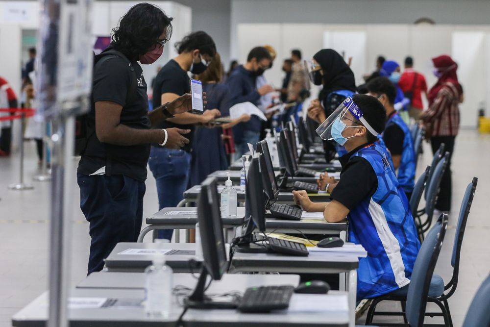 Members of the public register their personal details before receiving the AstraZeneca Covid-19 jab at Universiti Malaya, Kuala Lumpur May 5, 2021. u00e2u20acu201d Picture by Yusof Mat Isa