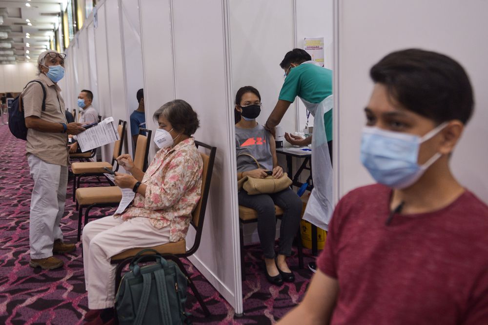 A health worker administers a dose of the AstraZeneca Covid-19 vaccine at the IDCC Ideal Convention Centre Shah Alam May 31, 2021. u00e2u20acu201d Picture by Miera Zulyana